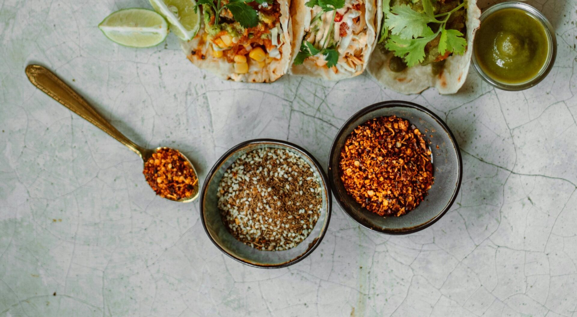 Brown and gray ceramic bowls arranged on a wooden surface.