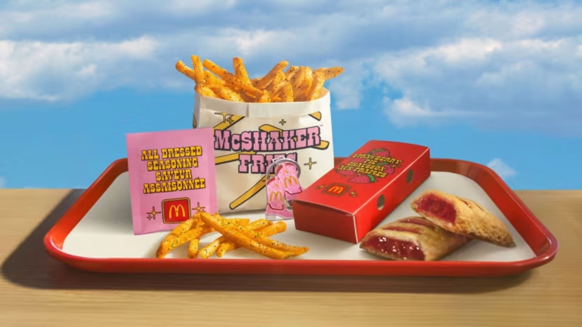 McDonald’s tray with McShaker fries, seasoning packet, and a fruit pie on display.