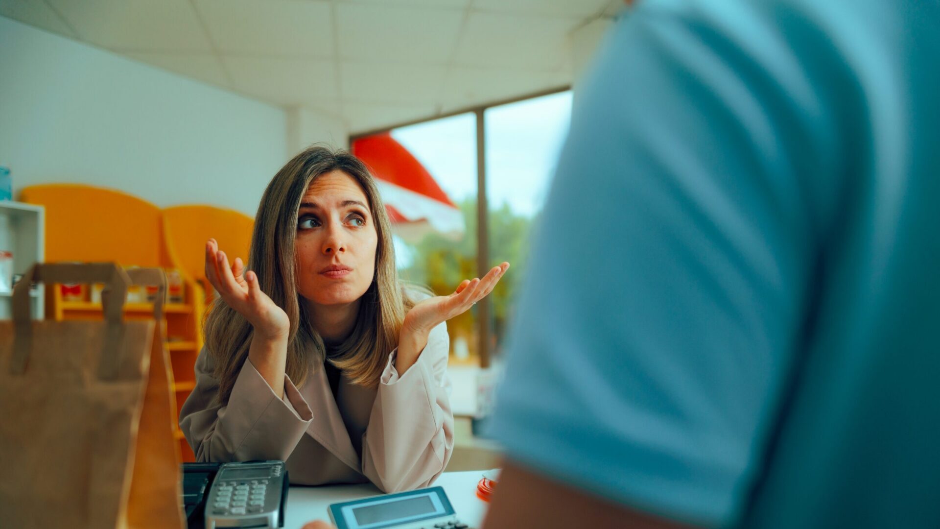 Customer looking puzzled while standing at a store counter.