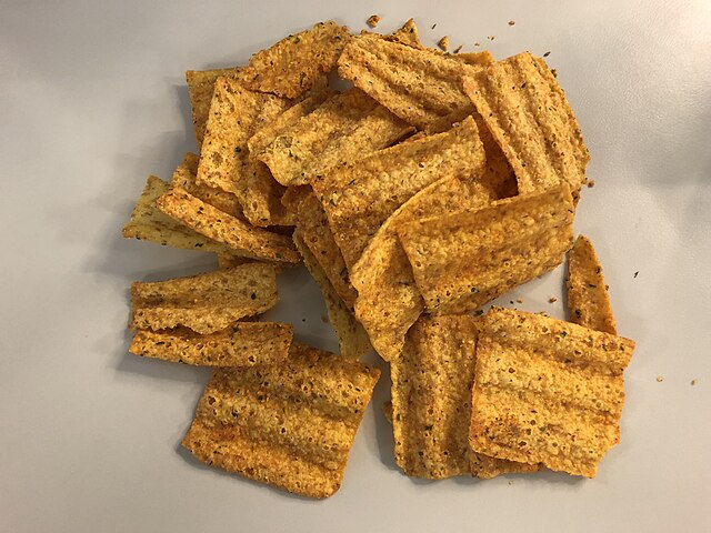 Pile of Sun Chips on a white surface.