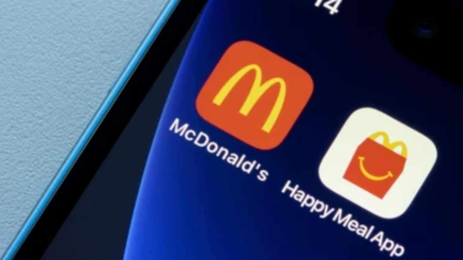 Close-up of a smartphone screen showing the icons for the official McDonald's app and the Happy Meal App side-by-side.