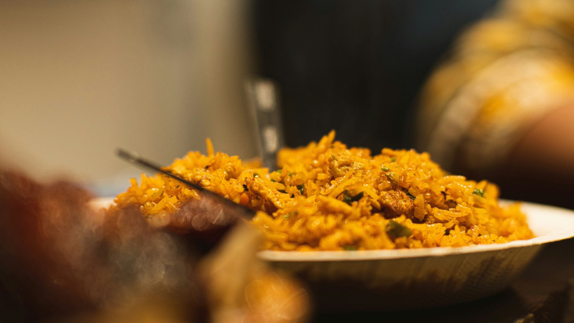 Close-up of a plate filled with seasoned rice and vegetables on a table