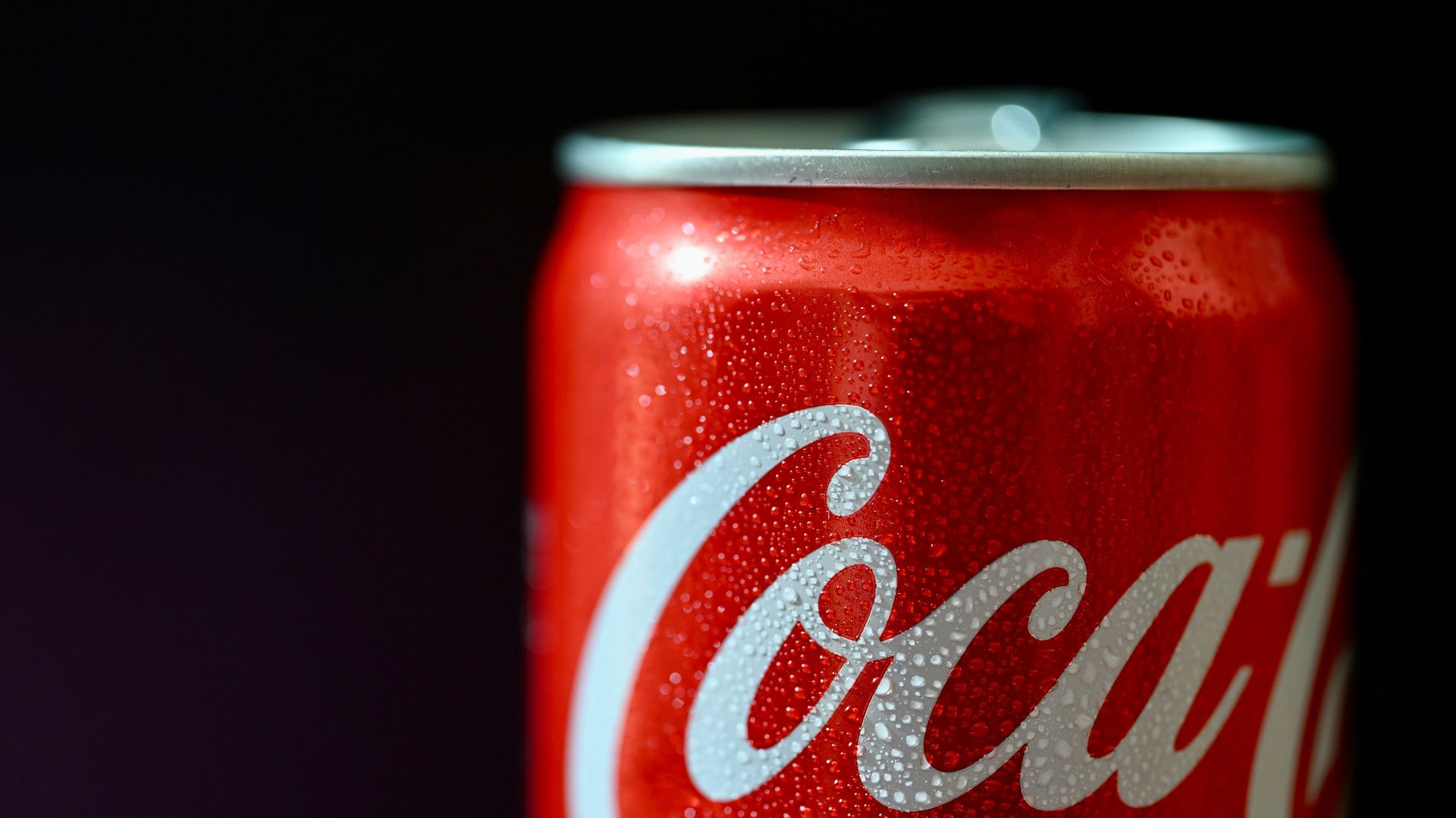 Close-up of a Coca-Cola Zero can with a cigarette resting in the opened tab.