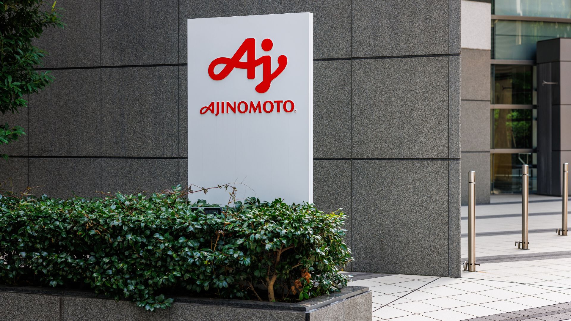 Ajinomoto company sign displayed outside an office building entrance
