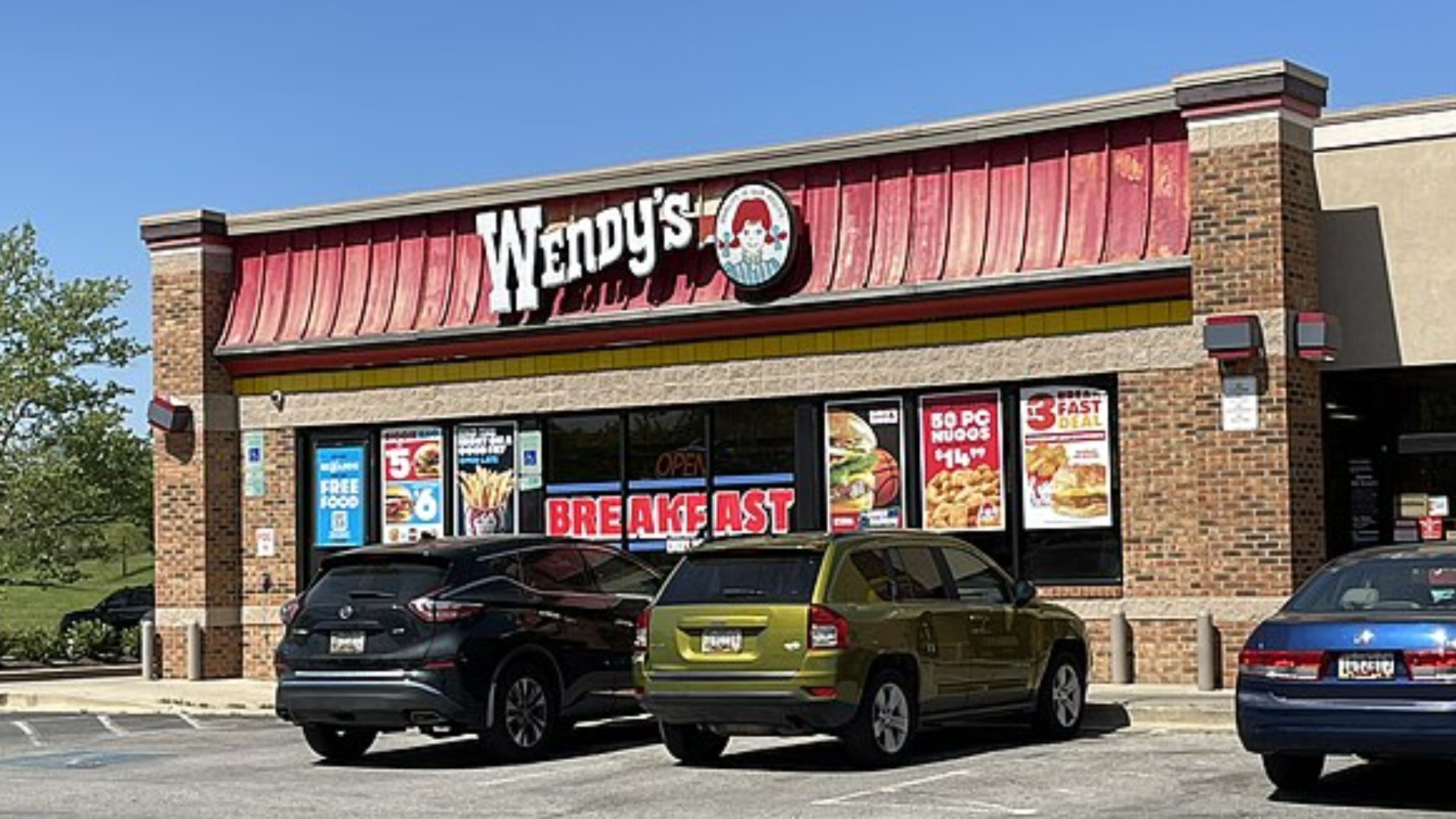 Wendy’s fast food restaurant with cars parked outside.