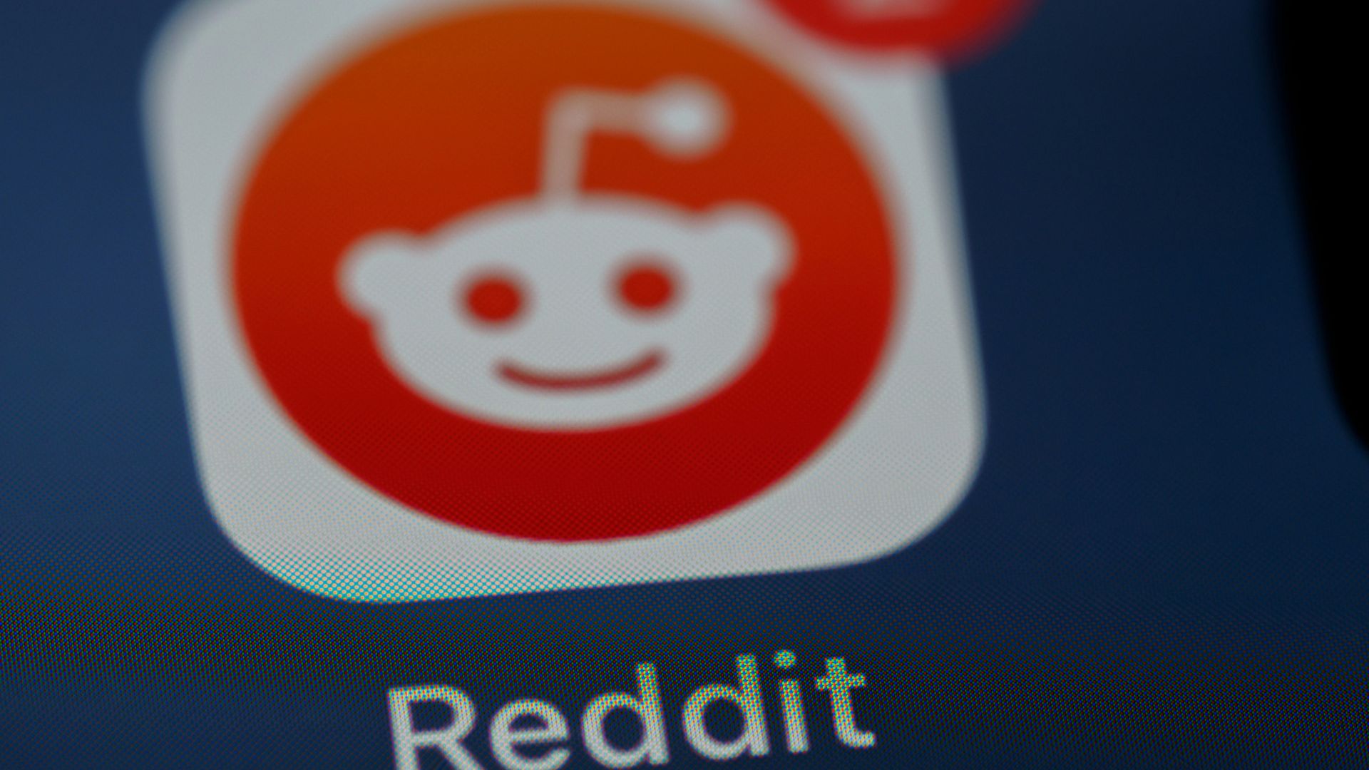 Close-up of the Reddit mobile app icon displayed on a smartphone screen