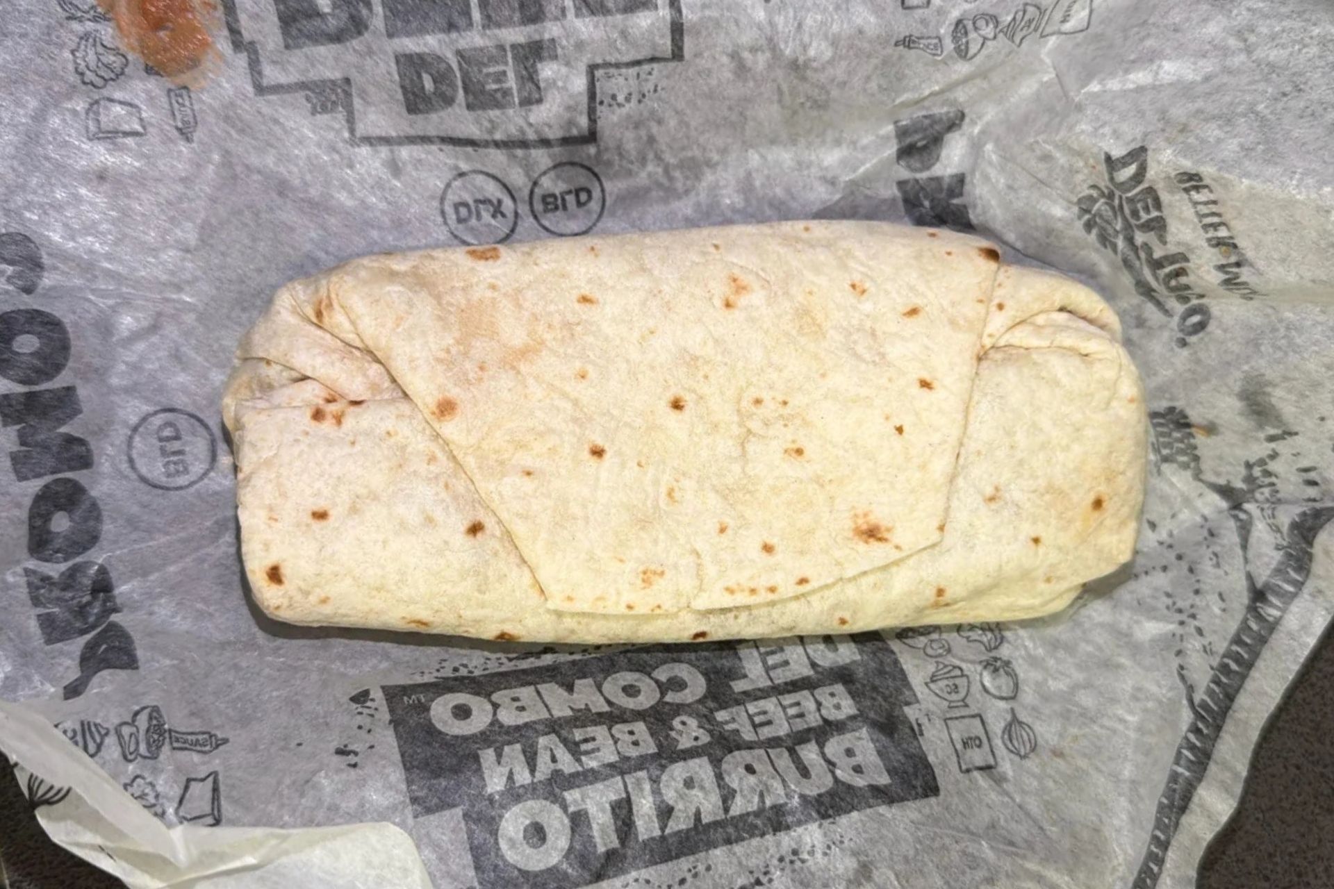 Del Taco Classic Burrito with new folded tortilla style shown in photo posted by a Reddit user.