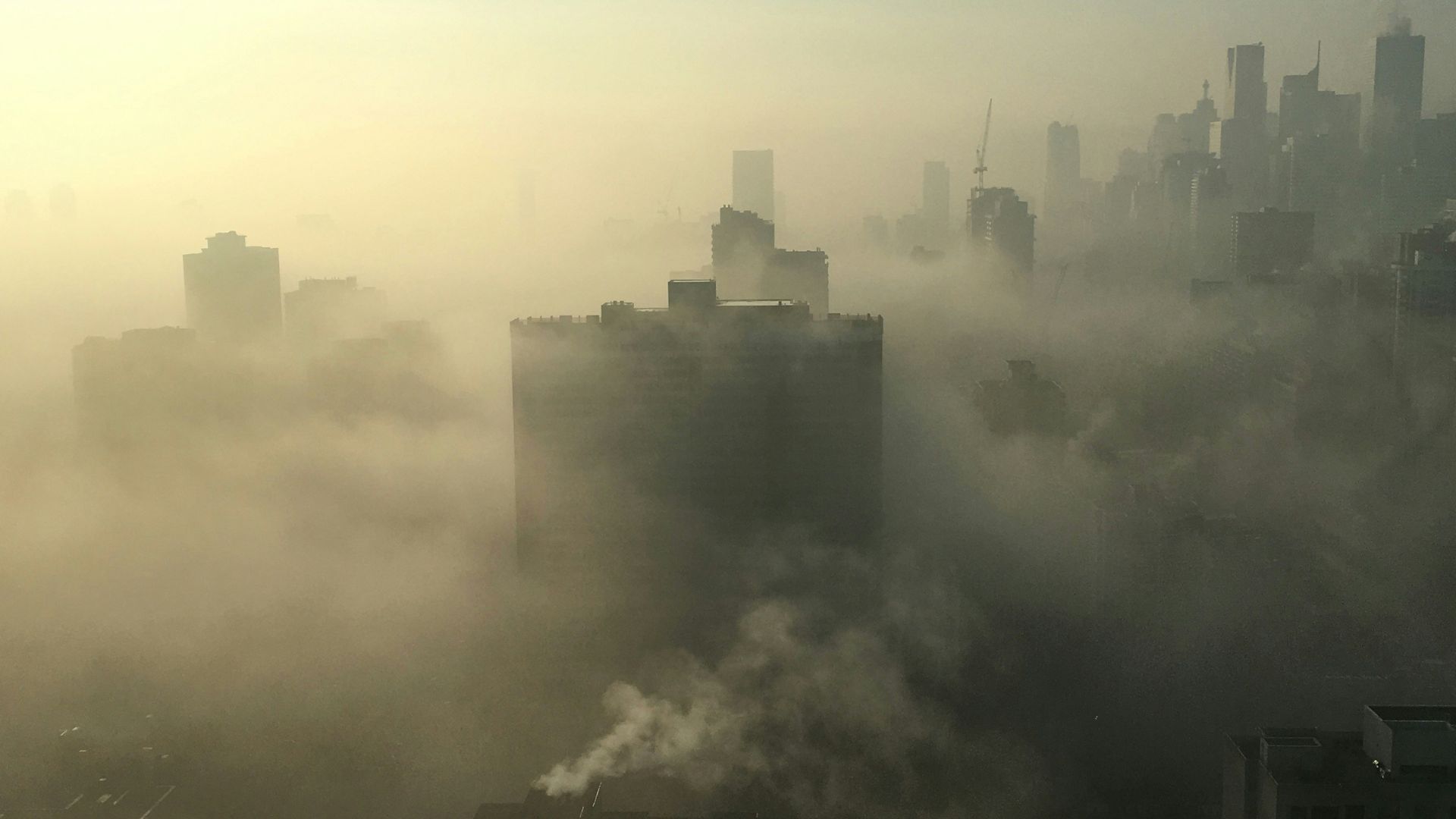 Photo from the sky of a city covered in dust and toxic air.