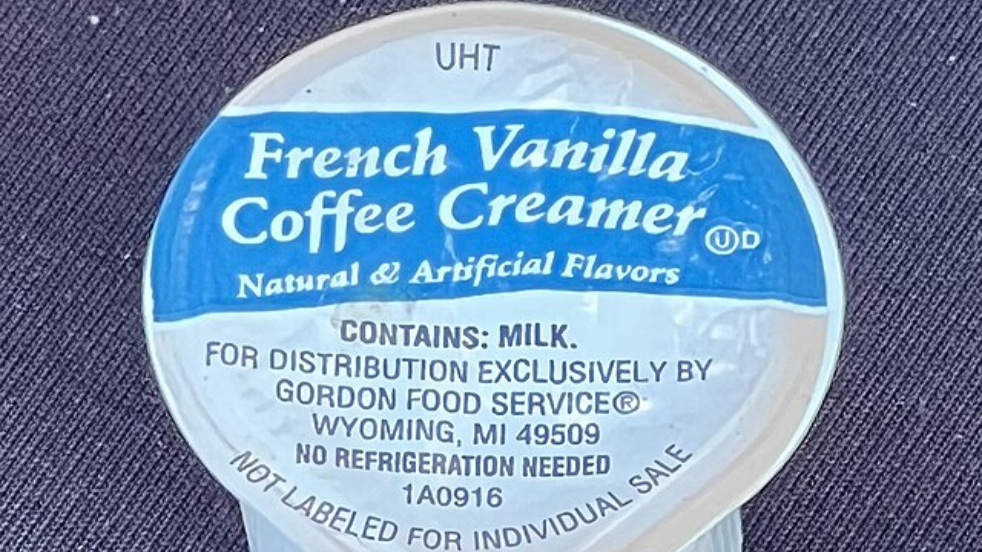Top view of a French Vanilla coffee creamer pod with a blue and white label.