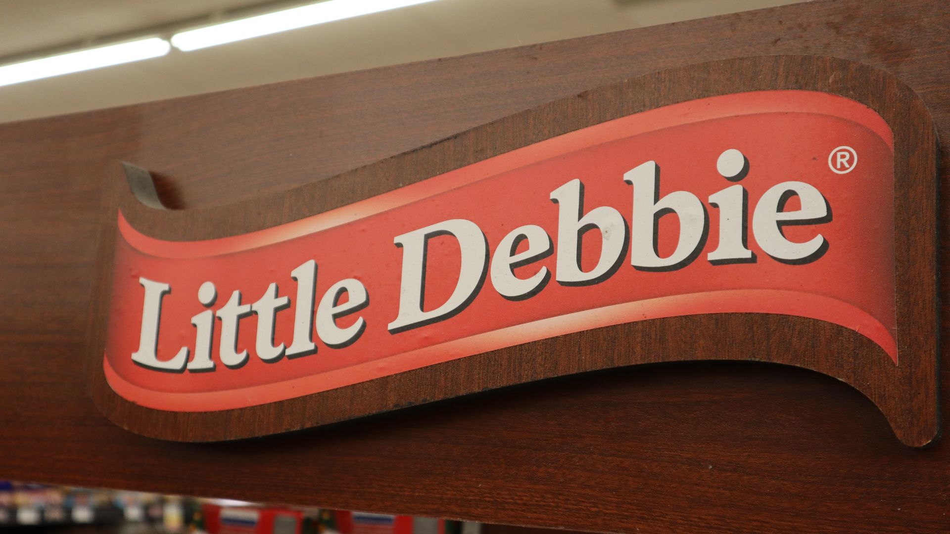 Close up on a Little Debbie logo above a display at a local grocers.