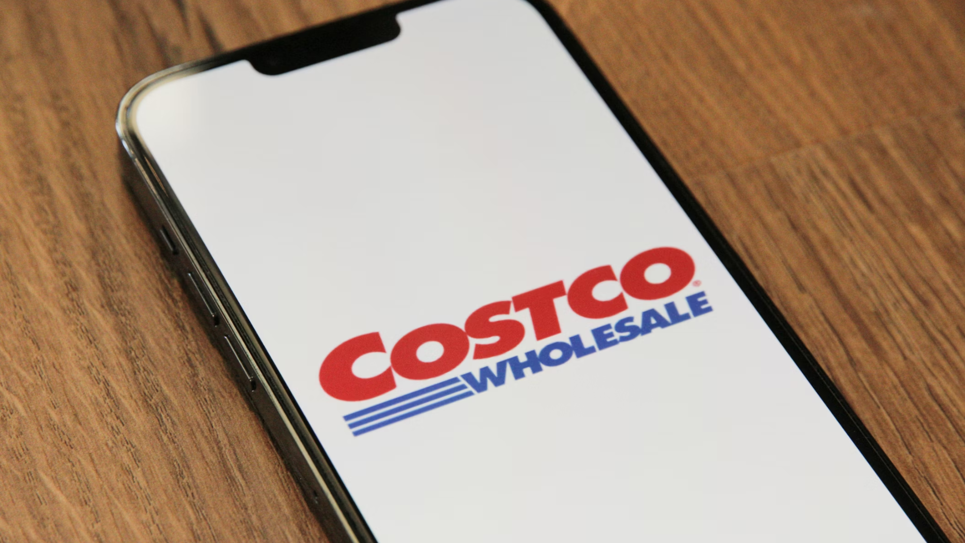 A close-up of a smartphone screen displaying the Costco Wholesale logo.