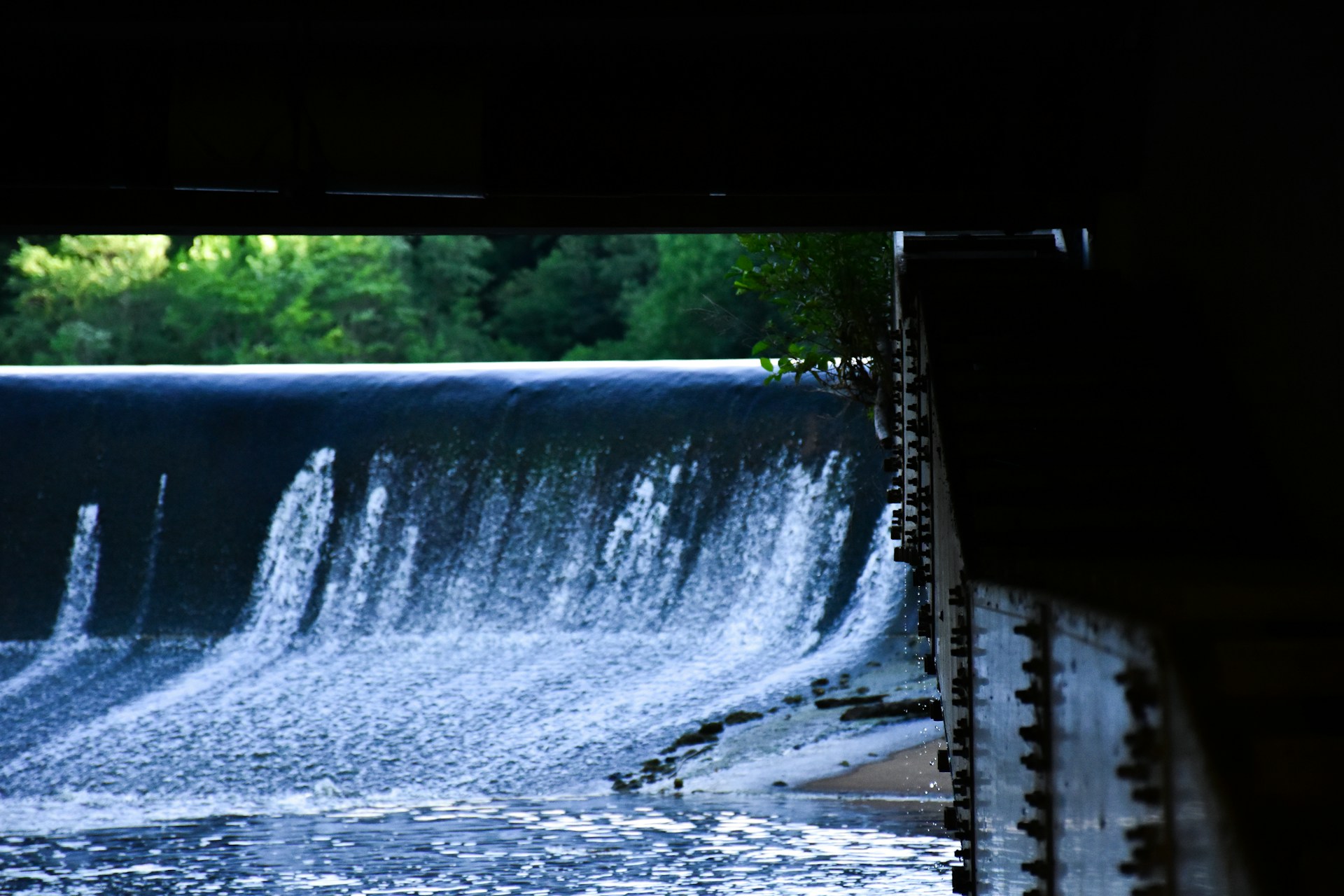 Water flowing over a dam.
