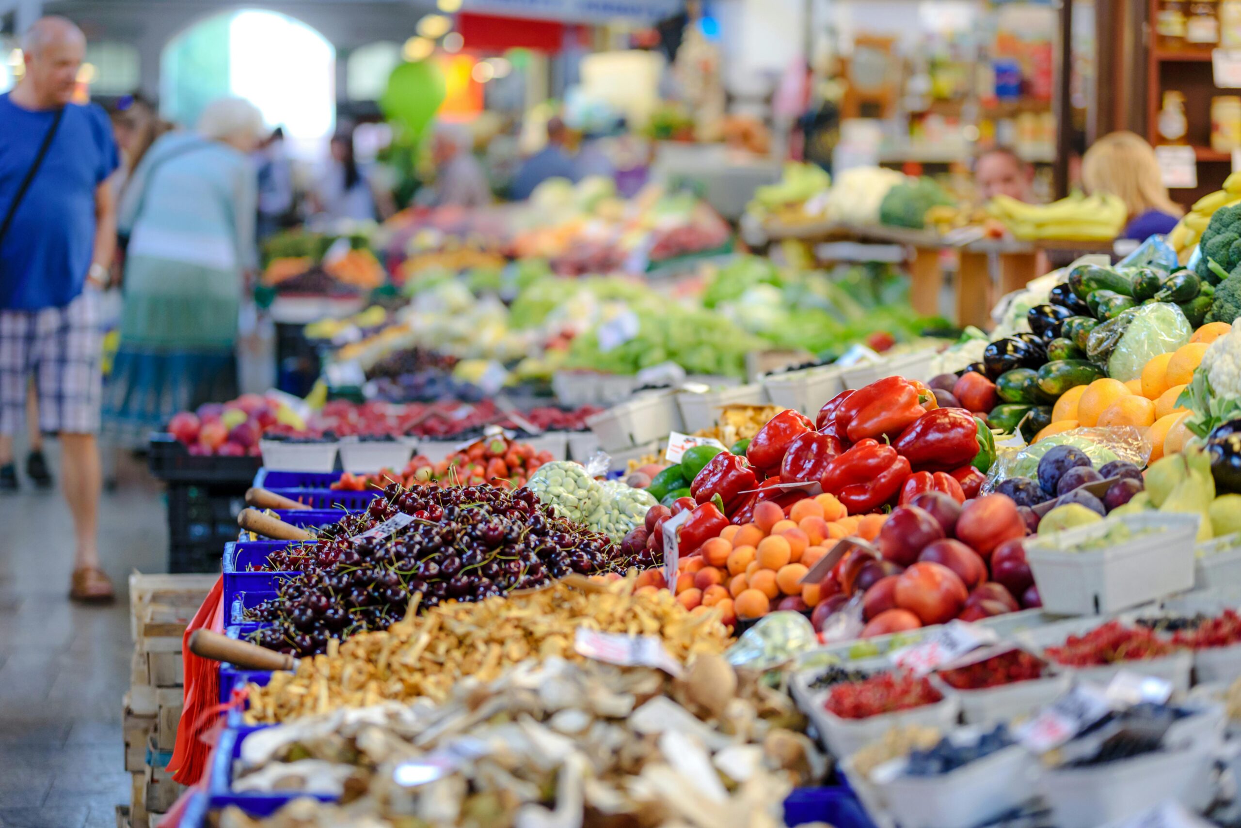 Fresh fruits and vegetables displayed at an outdoor market stall.