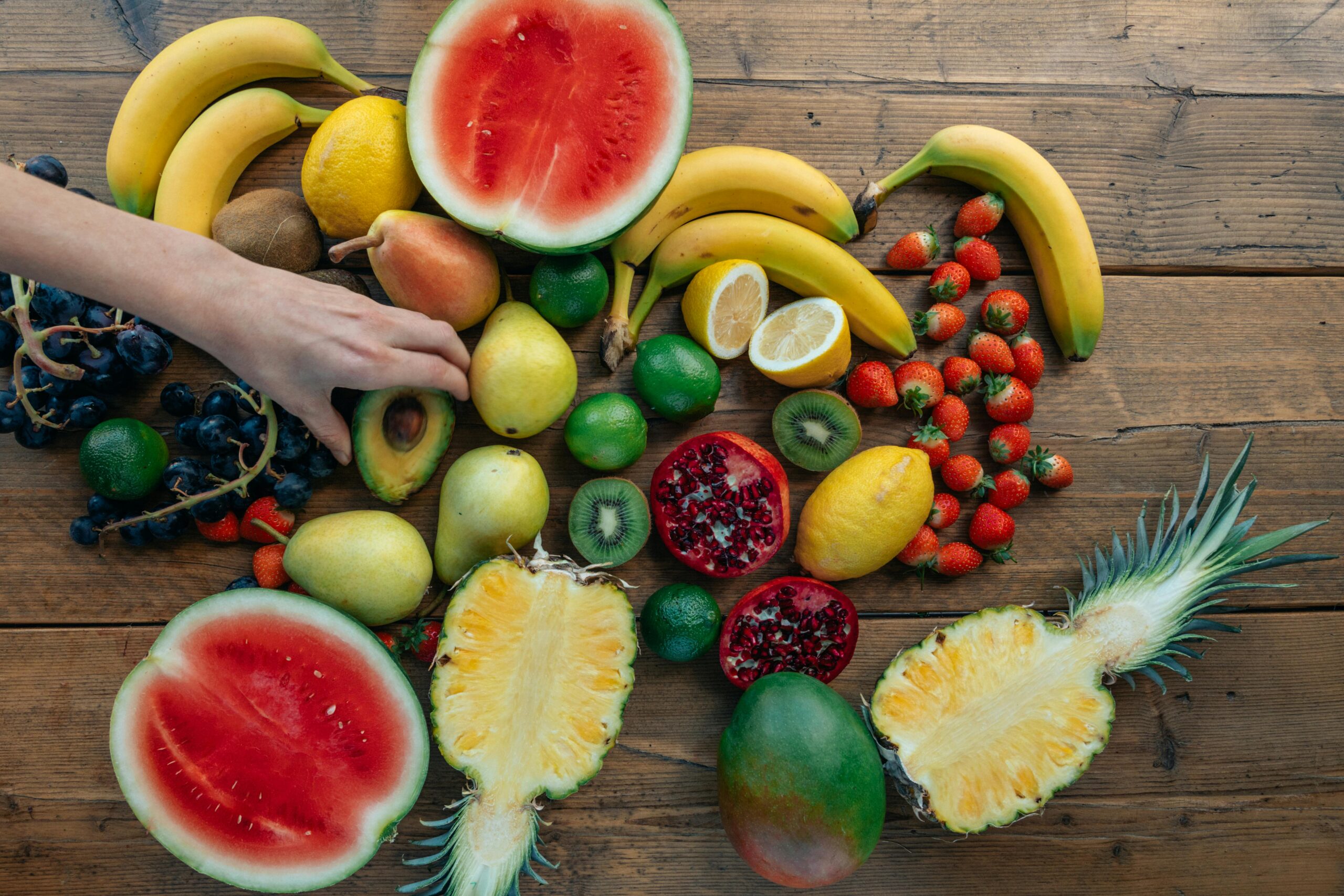 Assorted fresh fruits on wooden table.