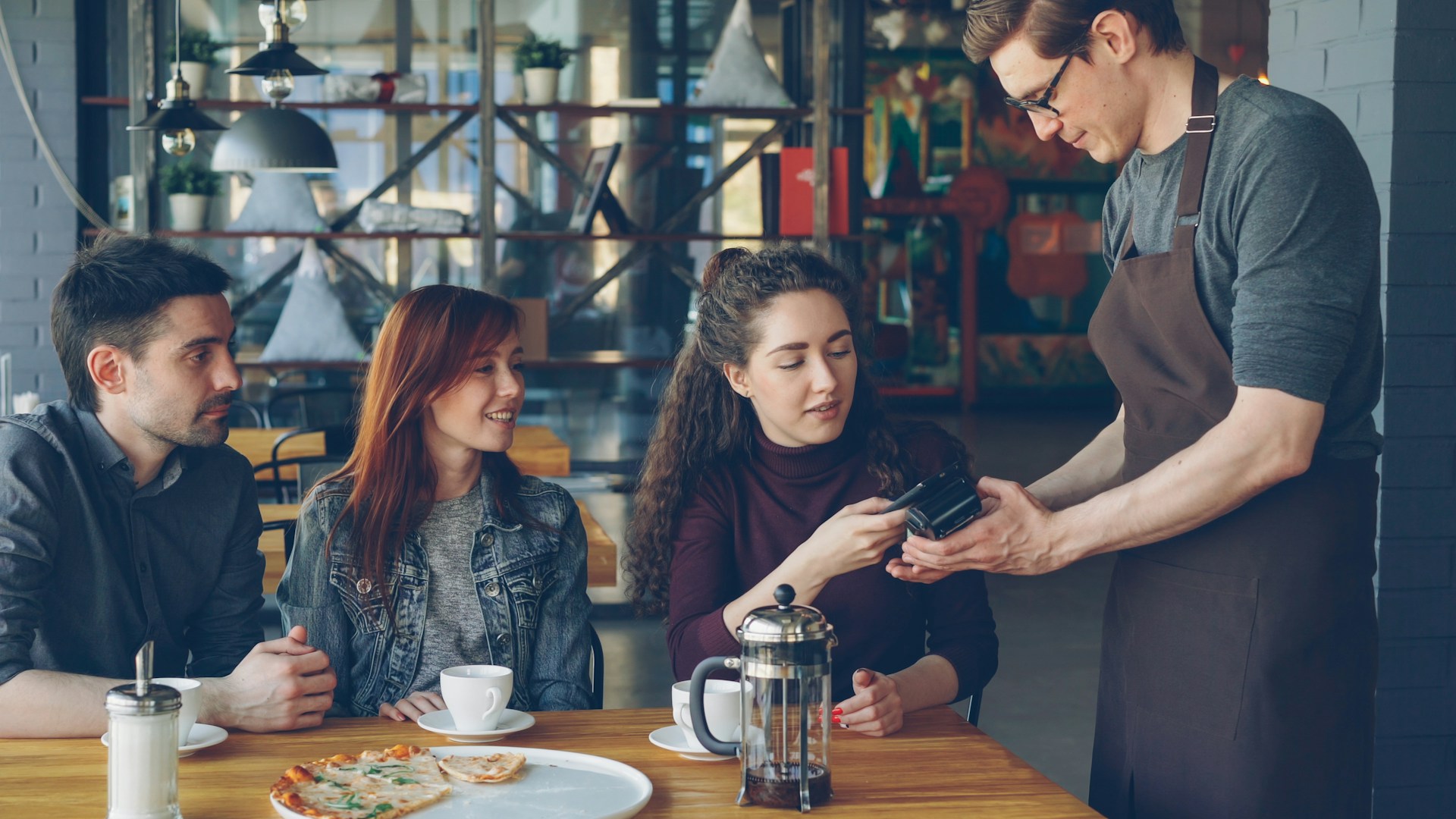 Customer pays by card at a restaurant.