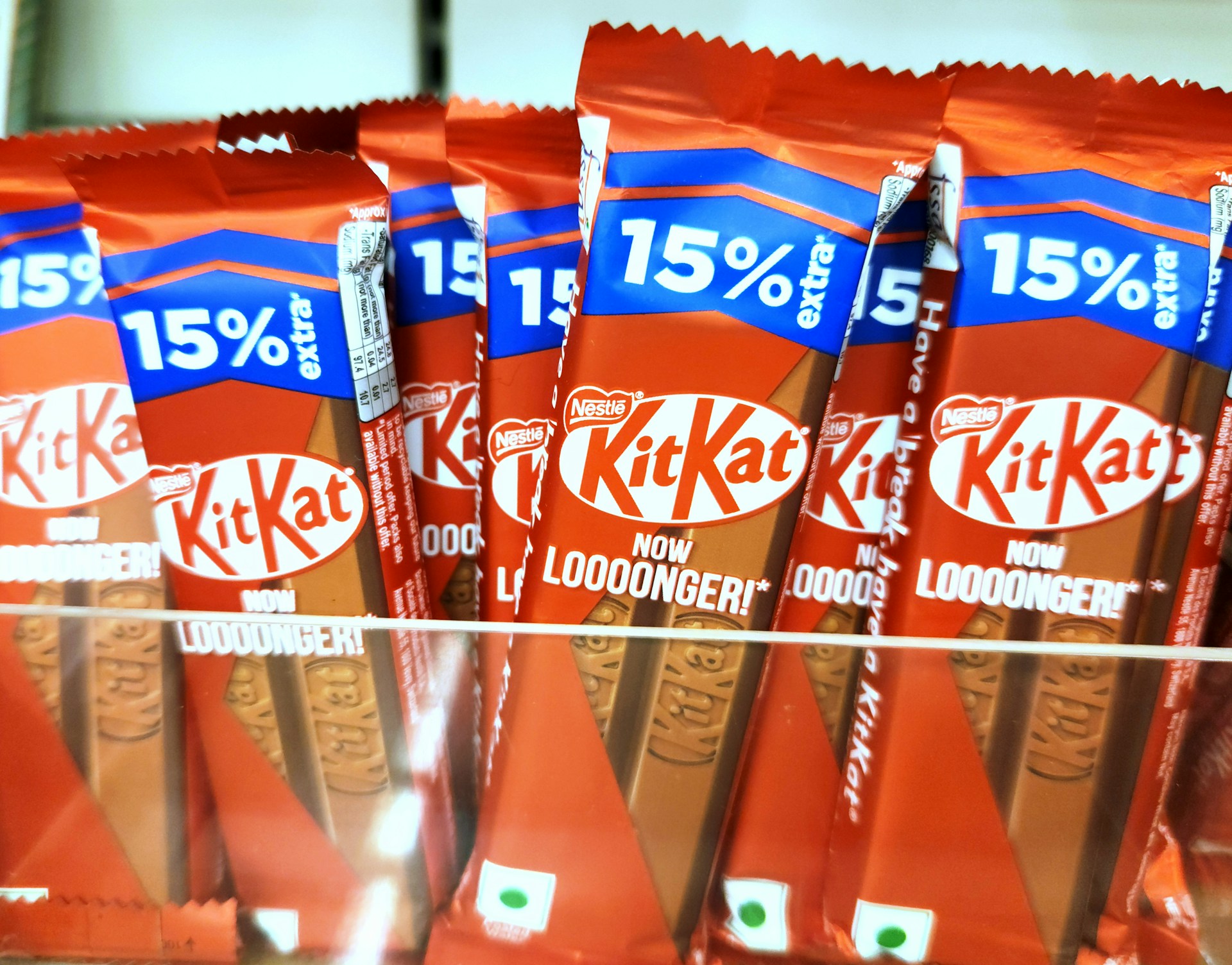 Packaged KitKat chocolate bars arranged in a row.