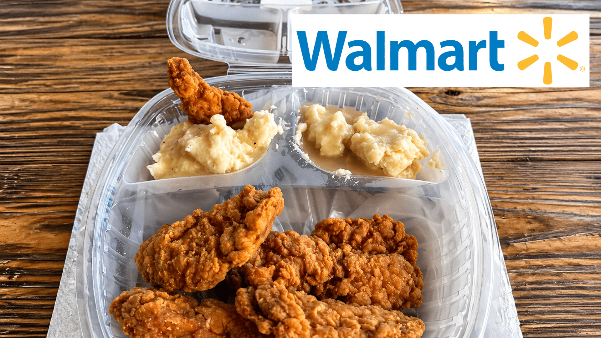 Walmart logo above a takeout container with fried chicken, mashed potatoes, and gravy on a wooden table.