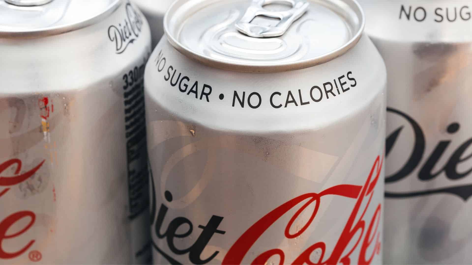 Several Diet Coke cans showing the words “No Sugar” and “No Calories.”