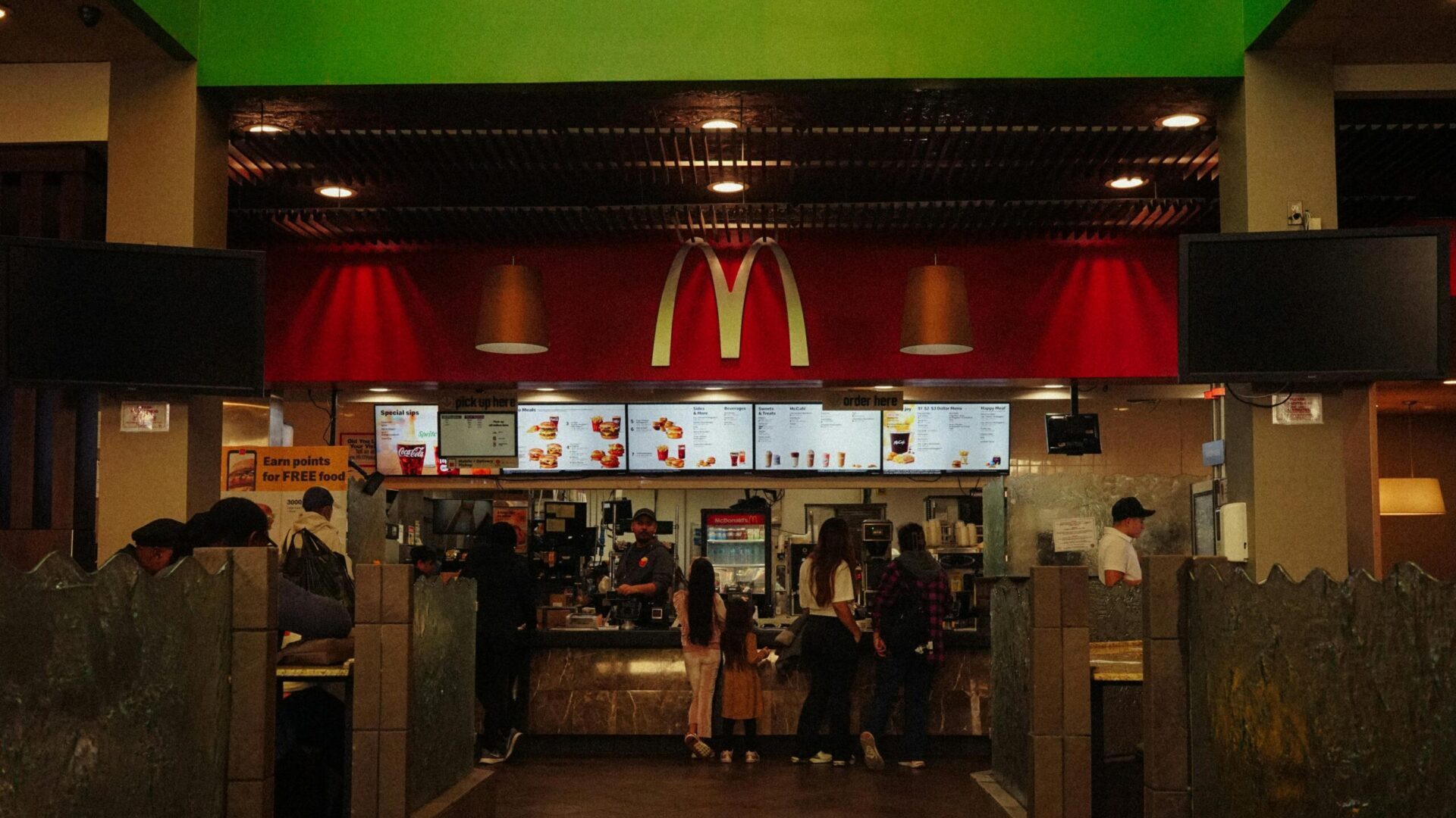 Interior of a McDonald's restaurant with customers ordering at the counter.