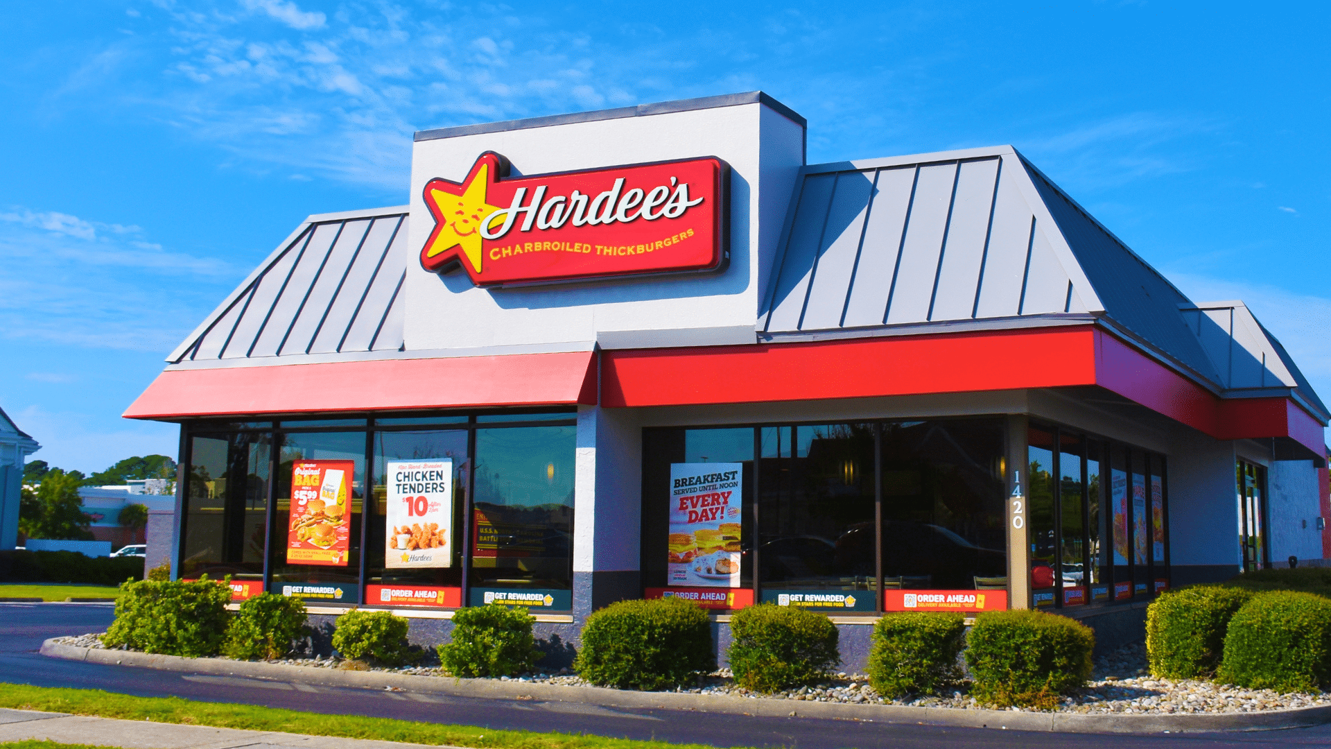 The exterior of a Hardee's fast-food restaurant building on a bright, sunny day.