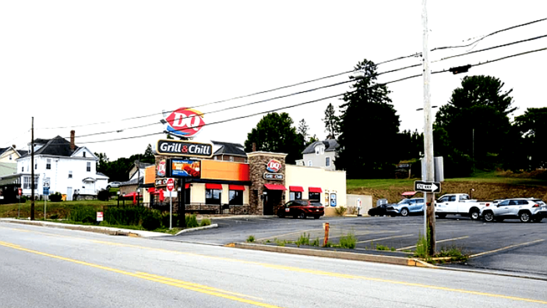 Dairy Queen Grill & Chill restaurant building with parking lot along roadside.