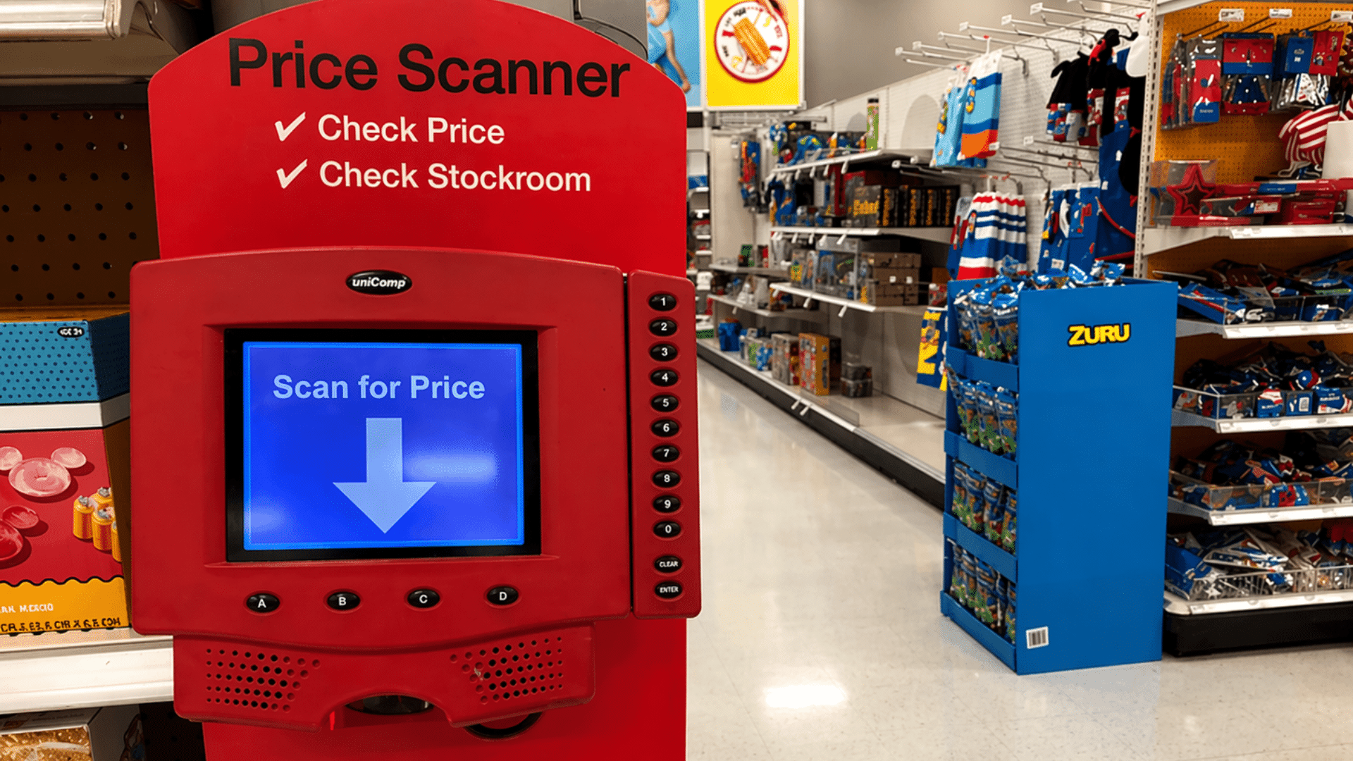 The digital screen shows a blue down arrow and the text "Scan for Price," with retail shelves and blue toy displays visible in the background.
