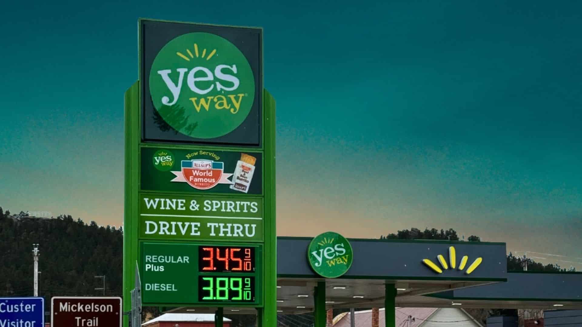 A Yesway convenience store sign advertising Allsup's burritos alongside fuel prices at a gas station.