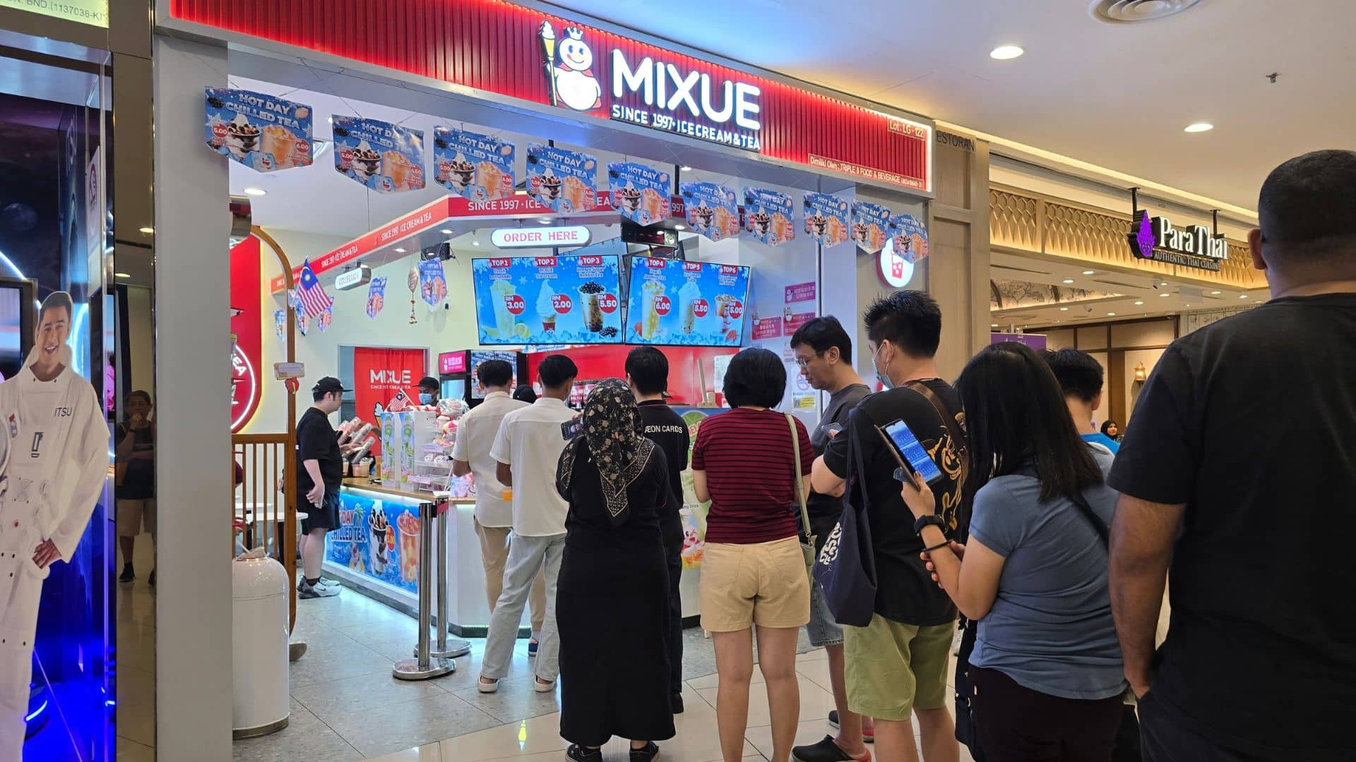 A long line of customers outside a small Mixue storefront inside of what looks like a mall.