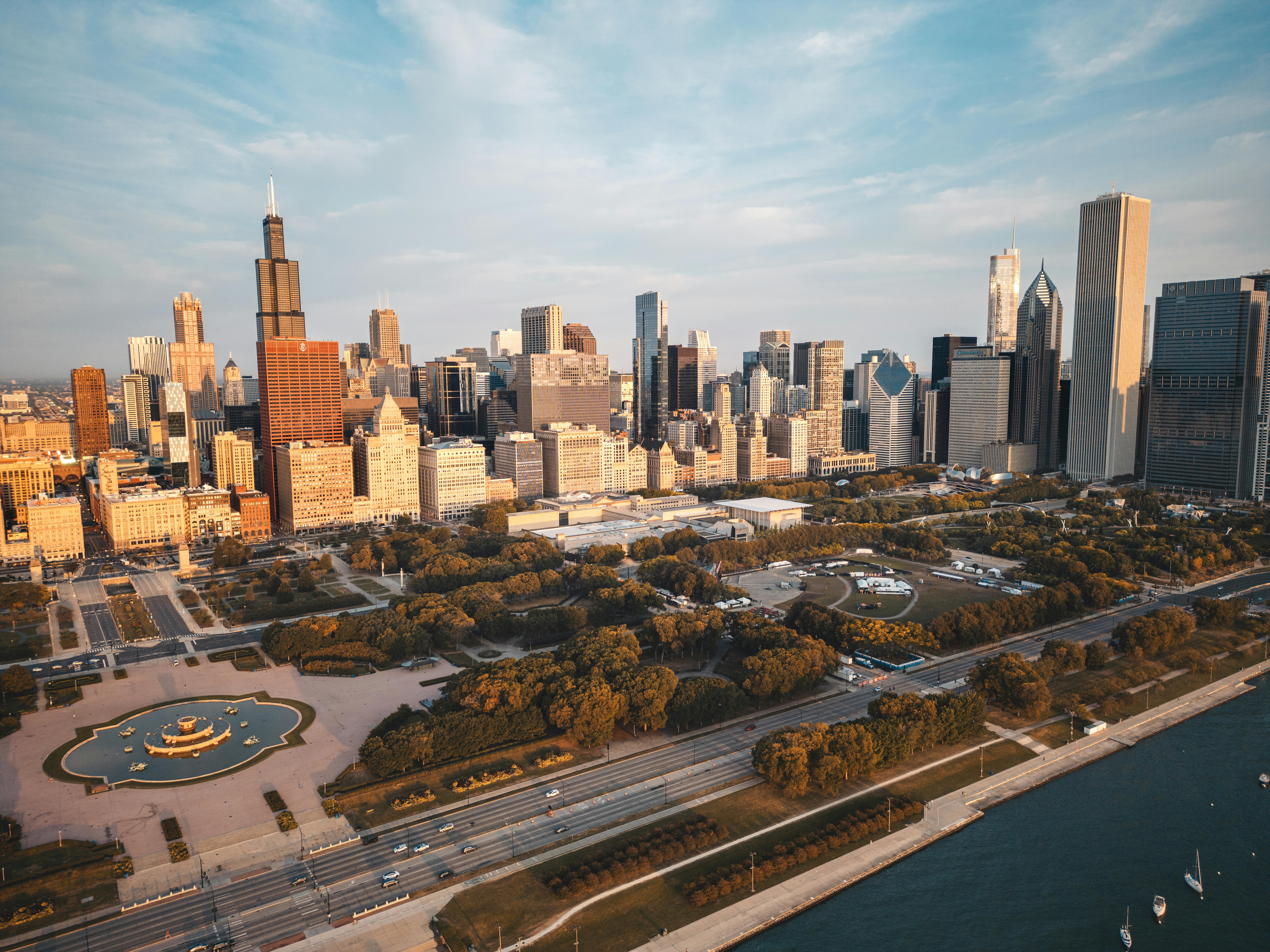 Chicago skyline with Willis Tower and Millennium Park along Lake Michigan waterfront at sunset.
