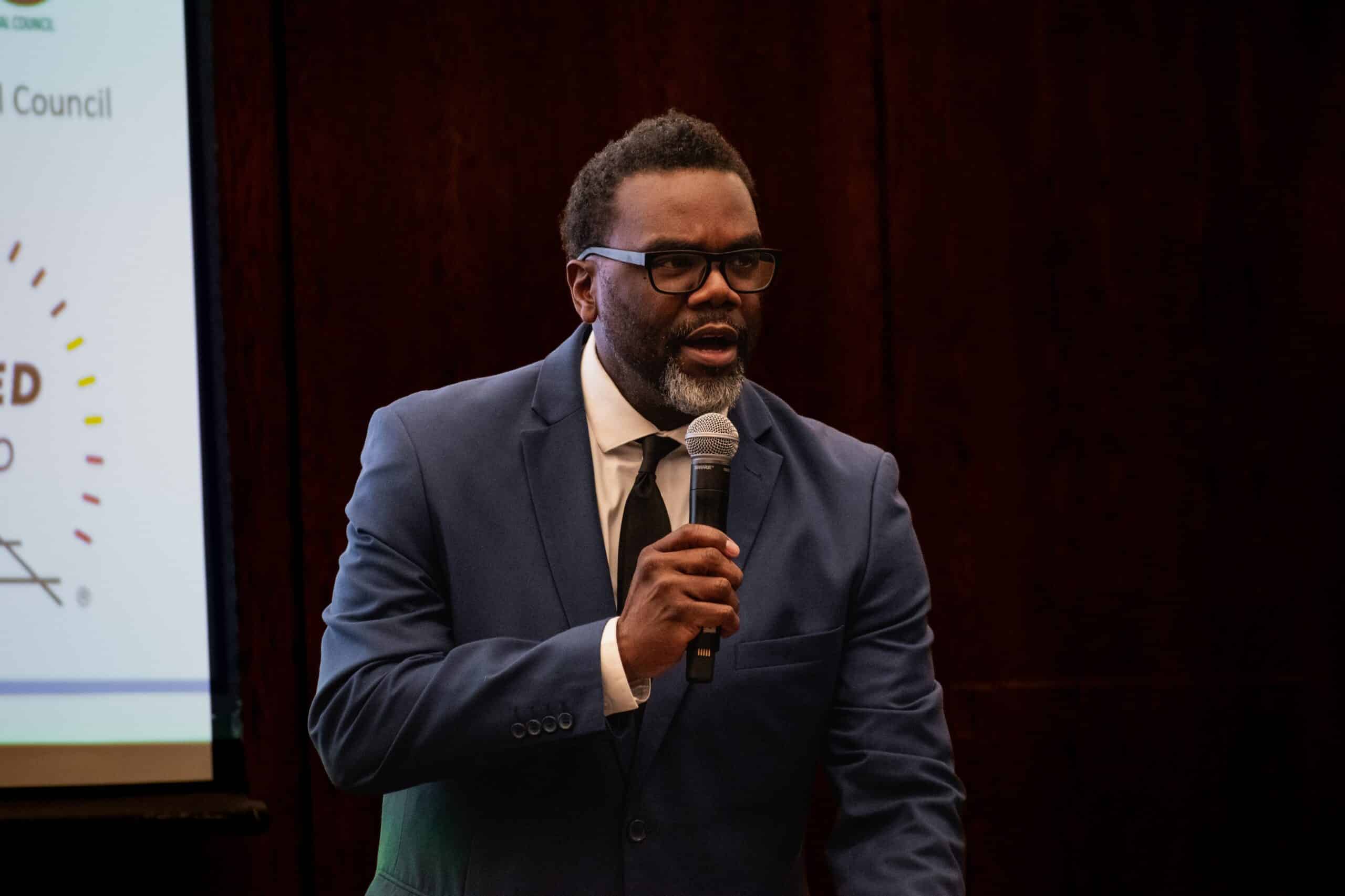 Chicago Mayor Brandon Johnson speaking into a microphone during a public event.