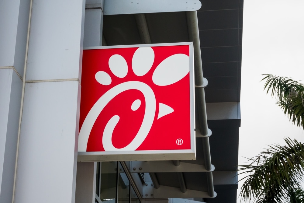 Chick-fil-A logo sign mounted outside a restaurant building.