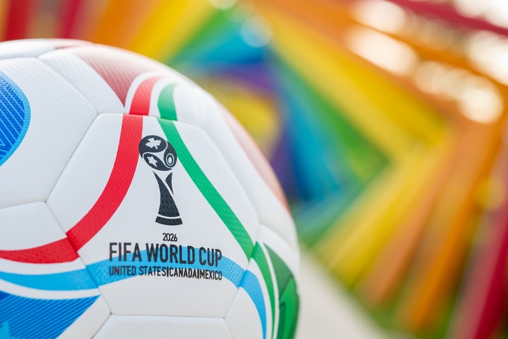 Close-up of 2026 FIFA World Cup soccer ball with tournament logo and colorful background.