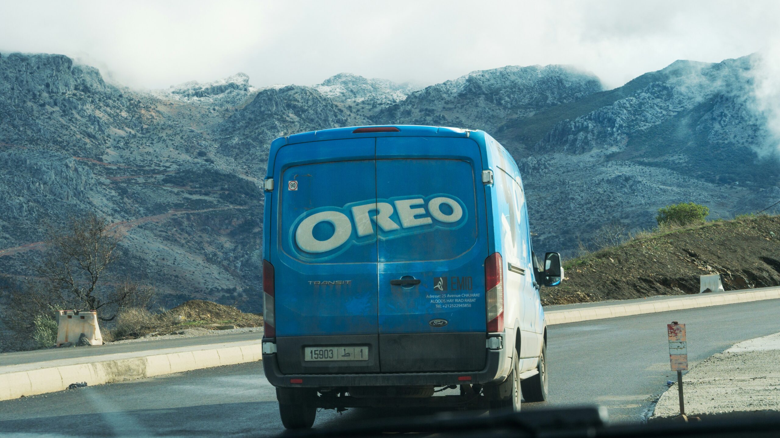 Oreo truck transportation of pack of cookies in a mountain way over the coutry.