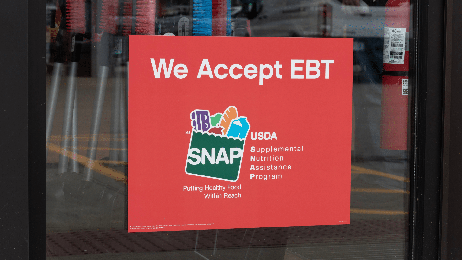A bright red sign in a store window that says