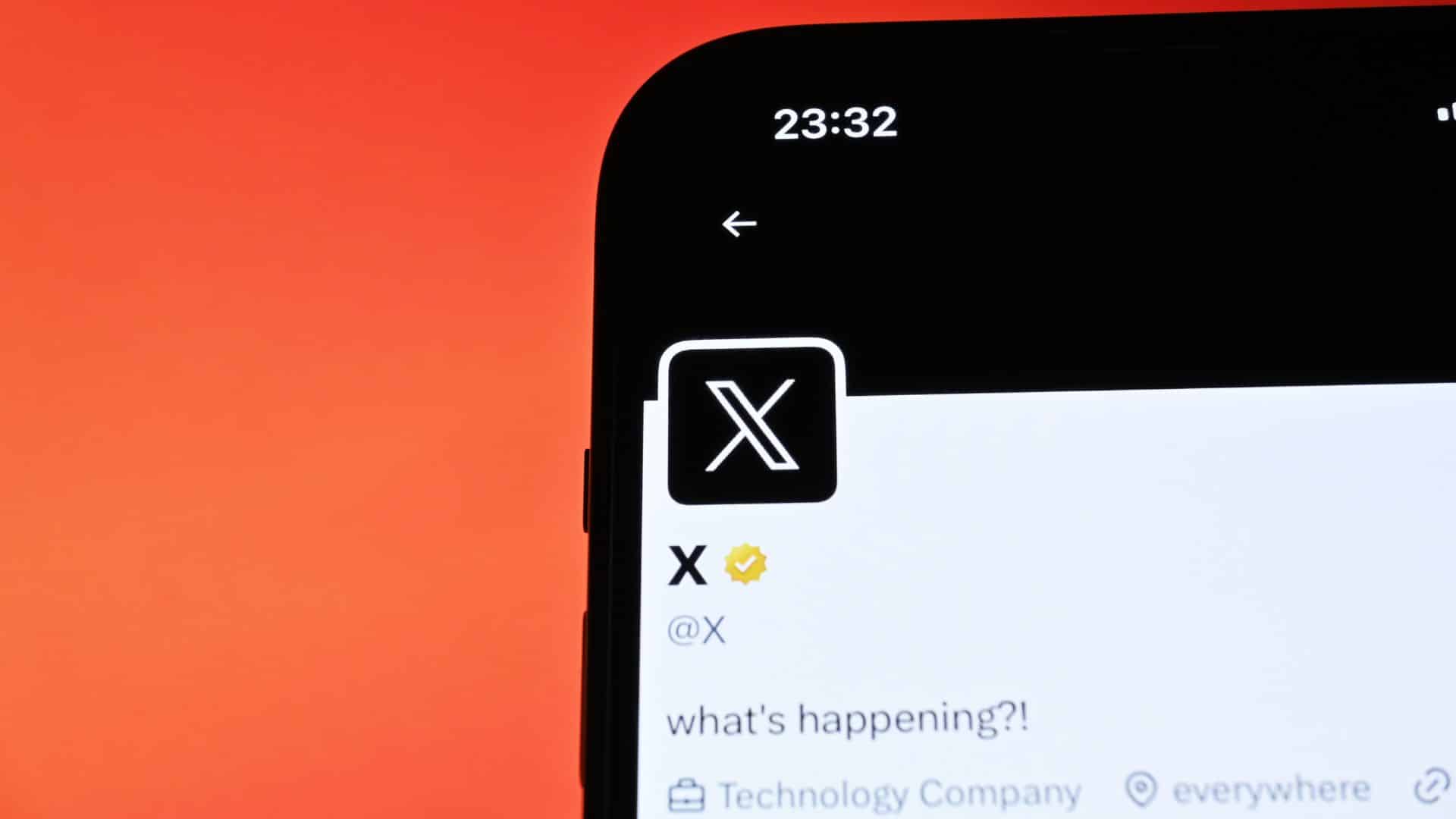 Smartphone screen displaying the X social media app logo against a red background.