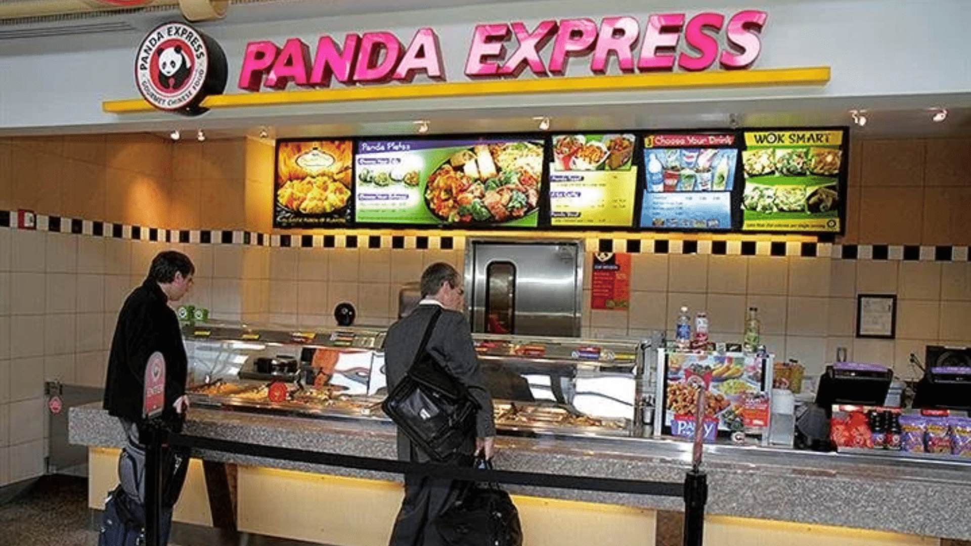 Customers ordering at a Panda Express counter with menu boards overhead.