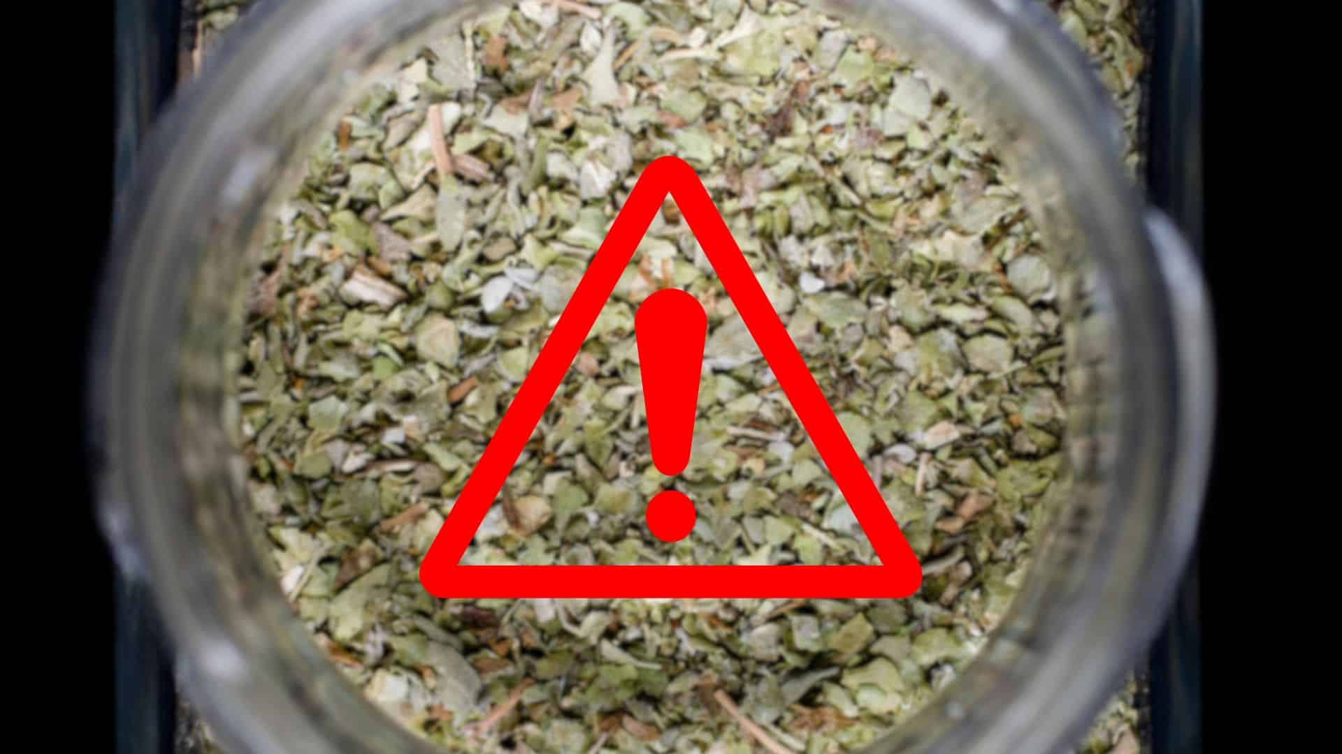 A jar of a mixed spice blend with a red warning symbol displayed over the seasoning.