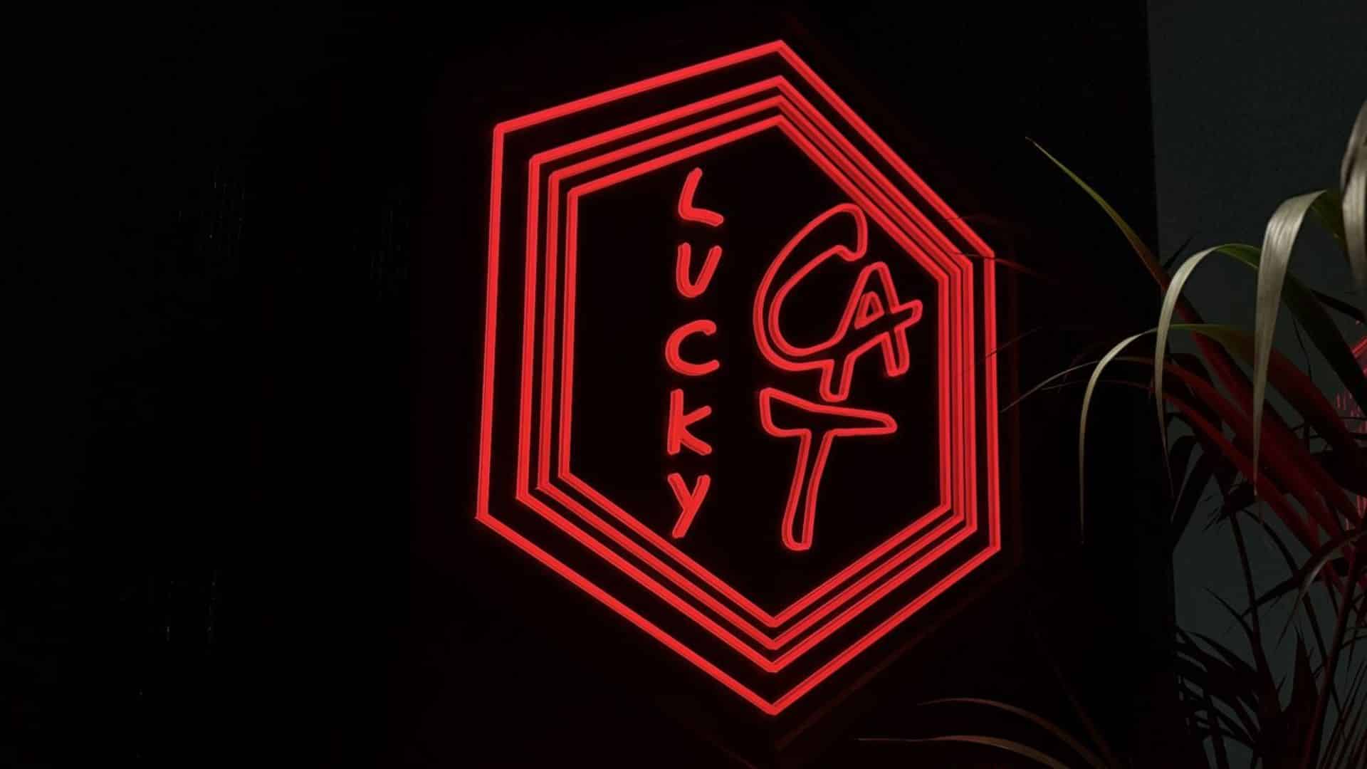 A close up shot of the glowing sign for Lucky Cat.