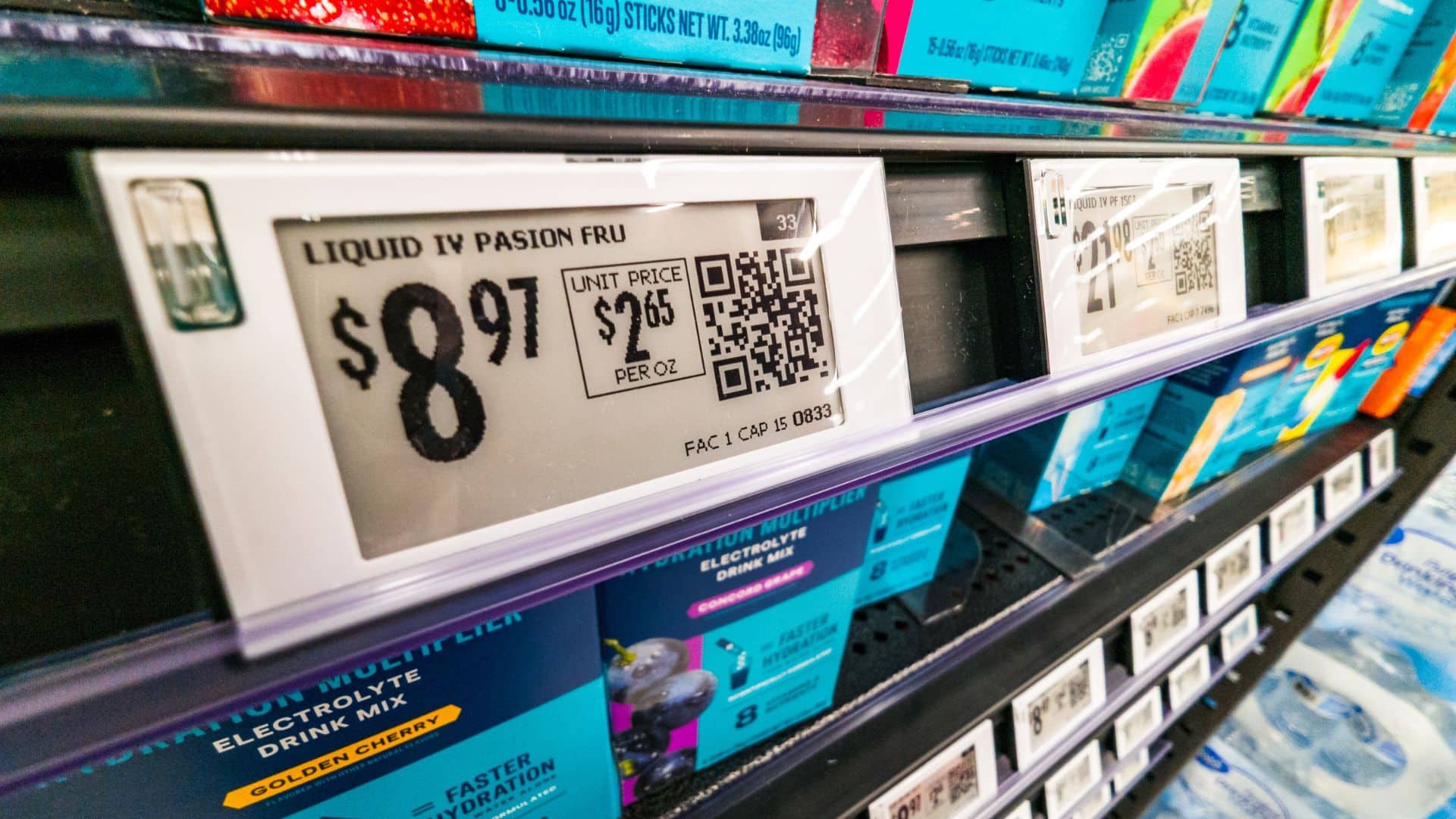 Close up of electronic price tag on grocery store shelf showing unit price.