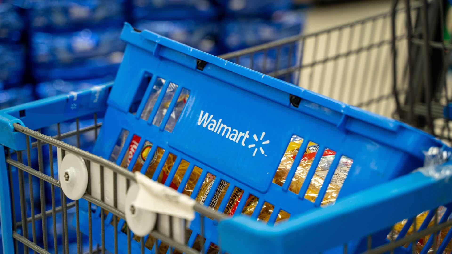 Walmart branded blue shopping basket inside store.