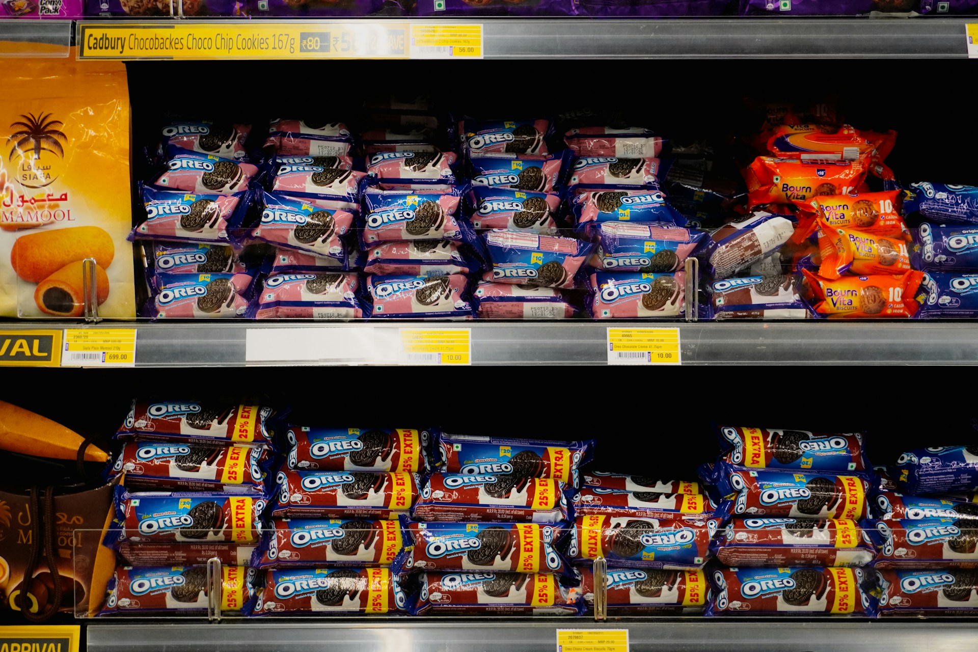 Packages of Oreo cookies displayed on grocery store shelves.