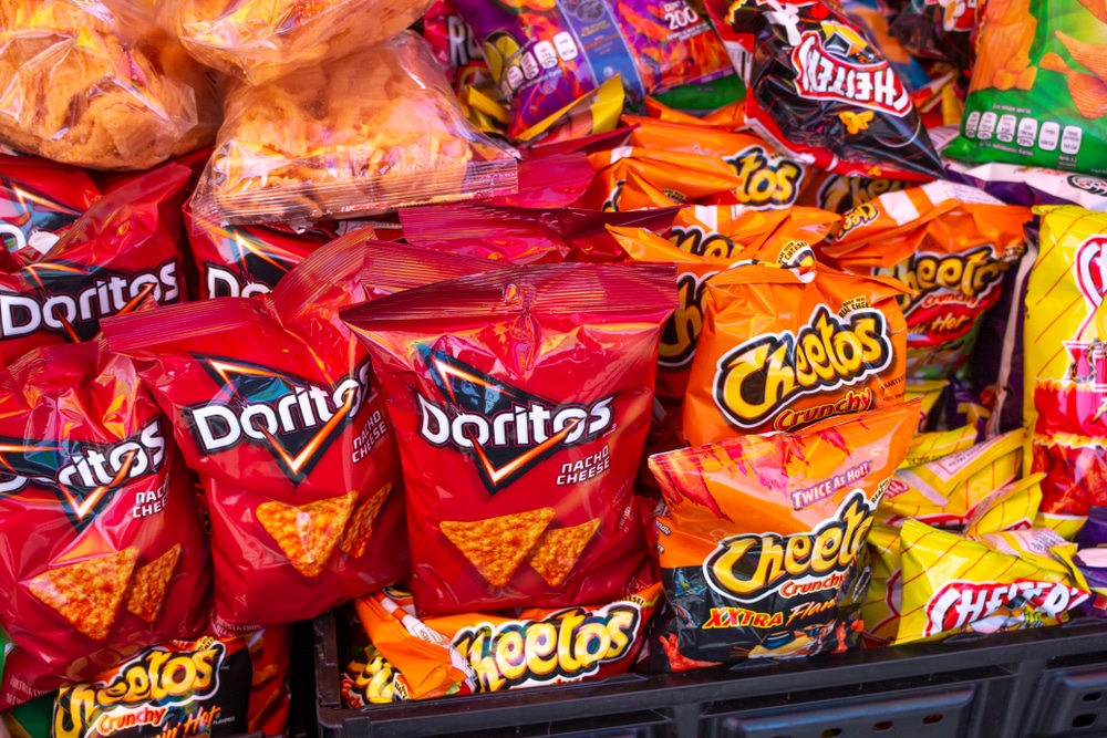 Bags of Doritos, Cheetos, and other snack foods on display.