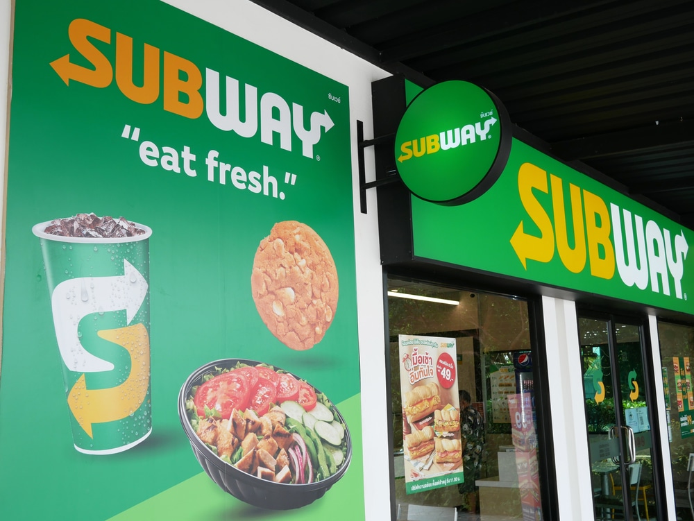 Subway restaurant storefront with green signage and “eat fresh” slogan displayed outside.
