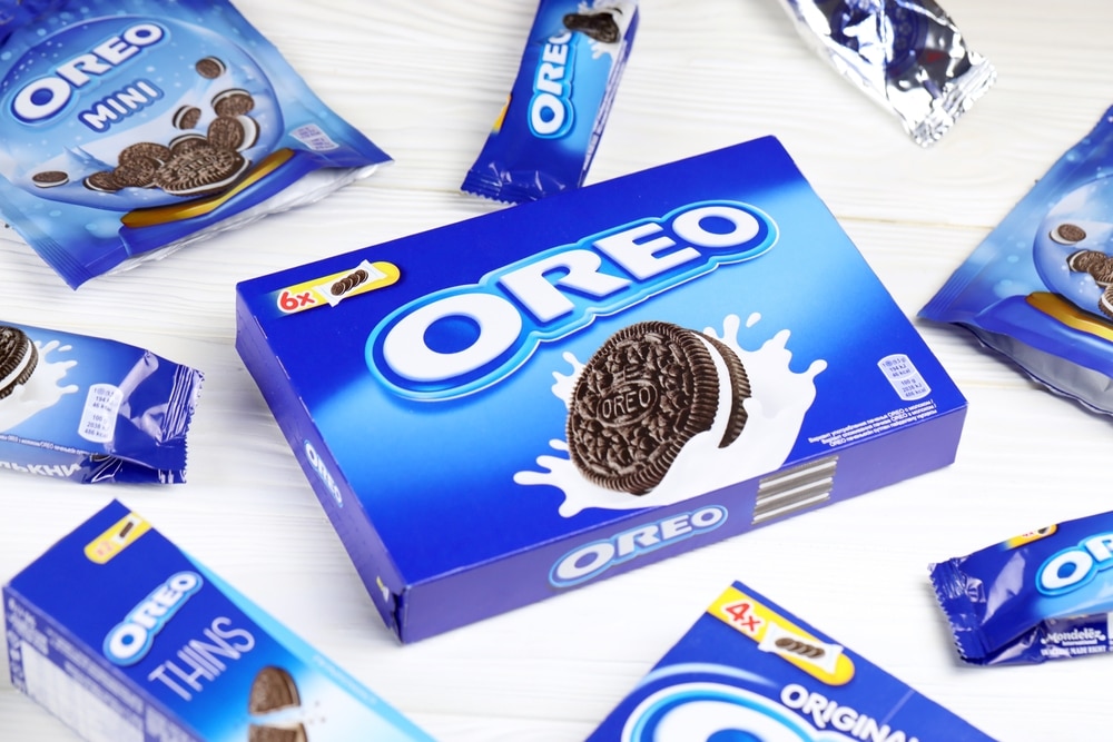 Assorted Oreo cookie packages and snack packs displayed on a white surface.