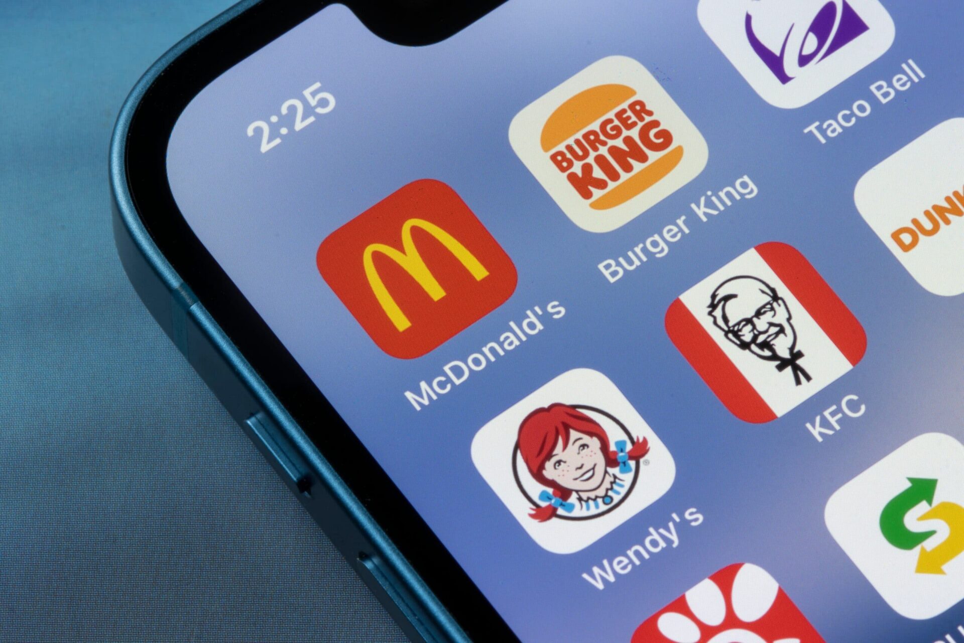 Fast-food restaurant app icons displayed on a smartphone screen.