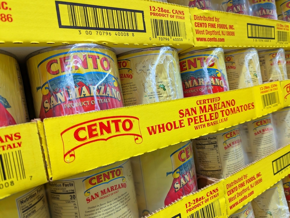 Cans of Cento San Marzano whole peeled tomatoes on store shelves.