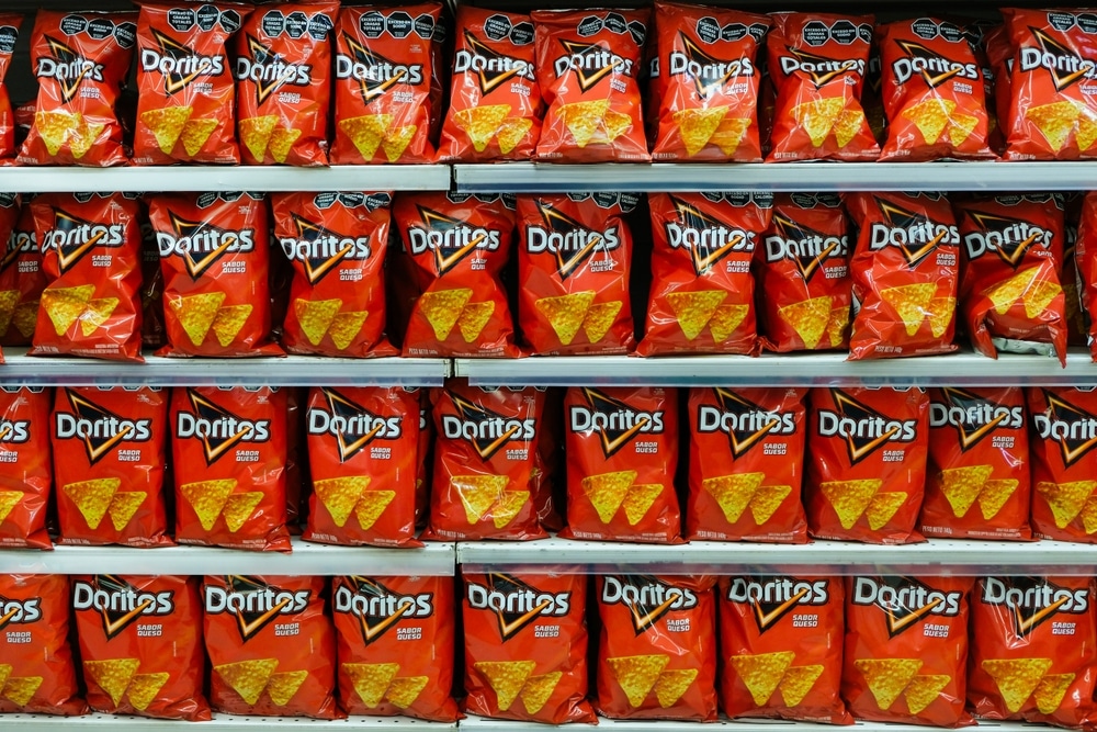 Bags of Doritos chips displayed on grocery store shelves.