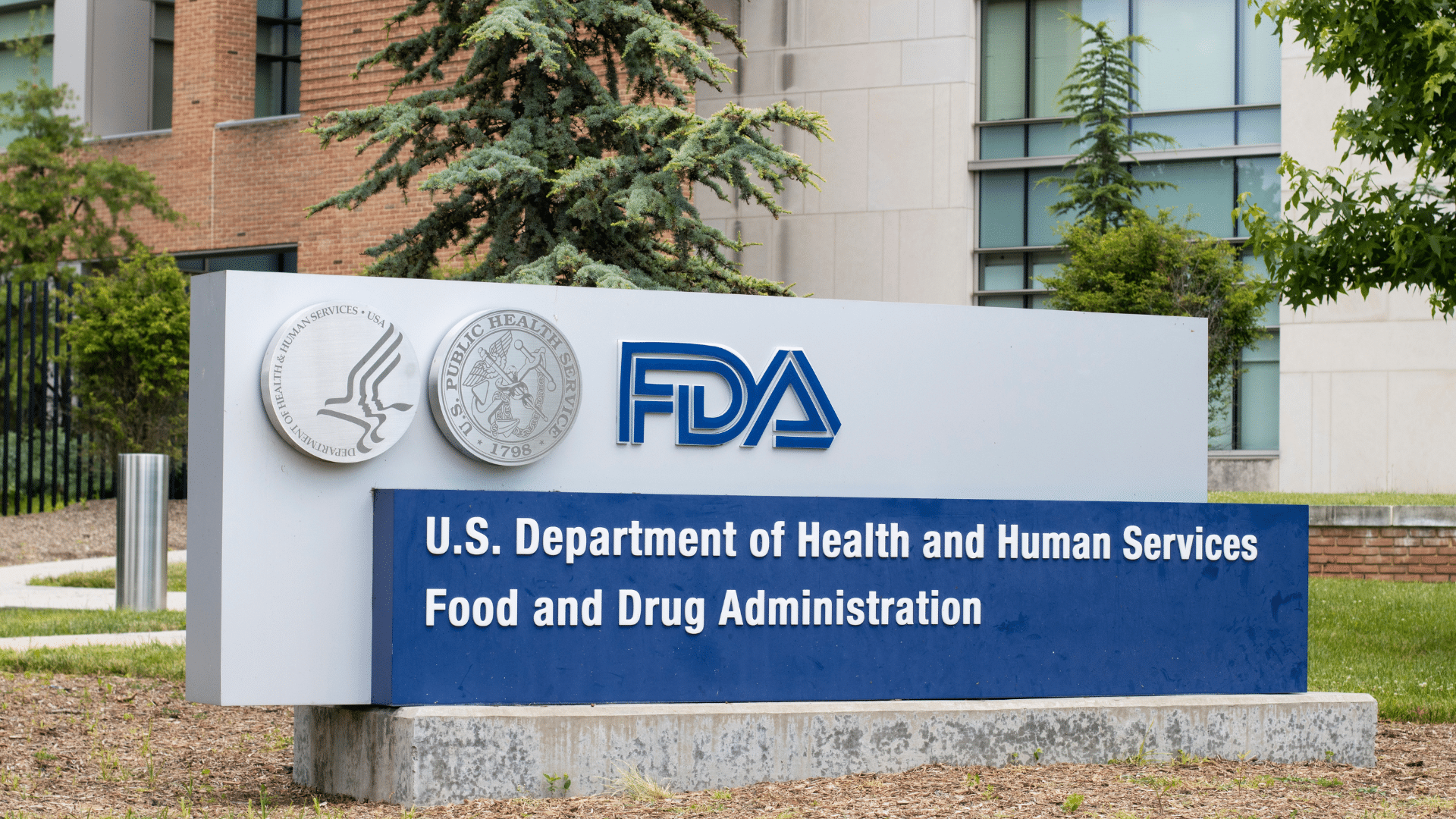 The official blue-and-white entry monument sign stands outside the U.S. Department of Health and Human Services Food and Drug Administration (FDA) headquarters.