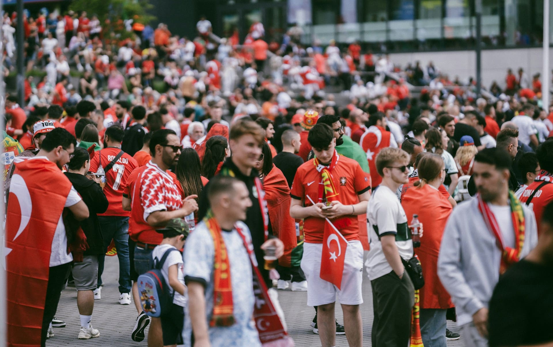 Soccer fans gather outside a stadium.
