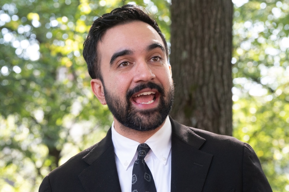 New York City mayoral candidate Zohran Mamdani speaking outdoors during a campaign event.